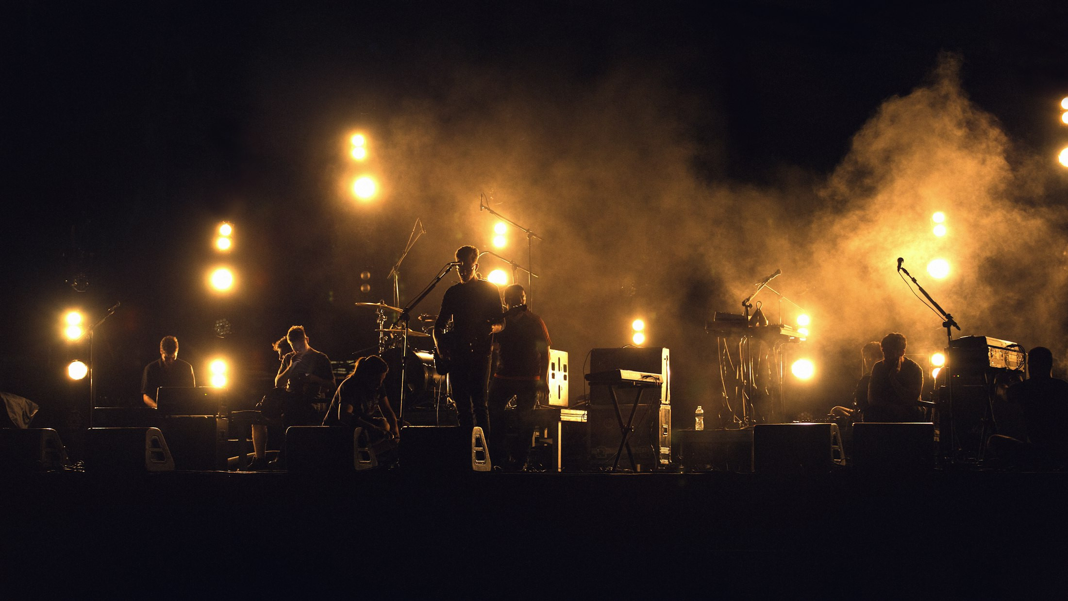 Banda a contraluz en el escenario, entre focos y humo